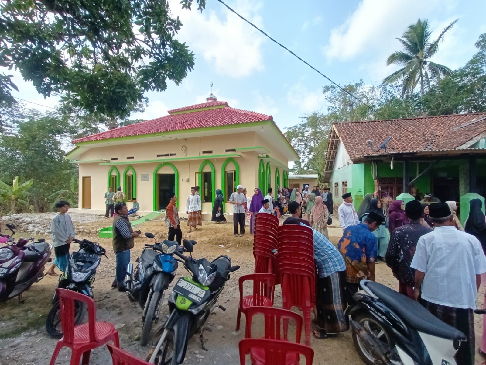Participants gather outside the mosque building.