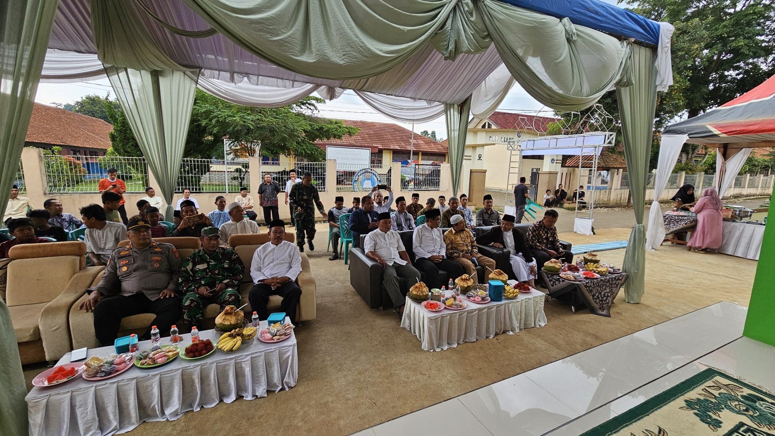 Guests seated beneath a canopy outside the mosque.