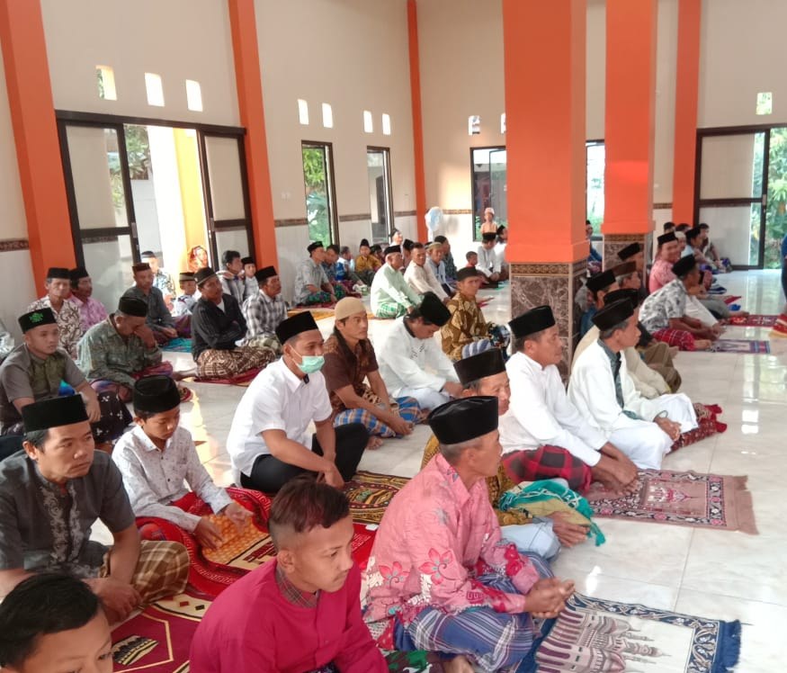 Worshippers gather inside the mosque prayer hall.