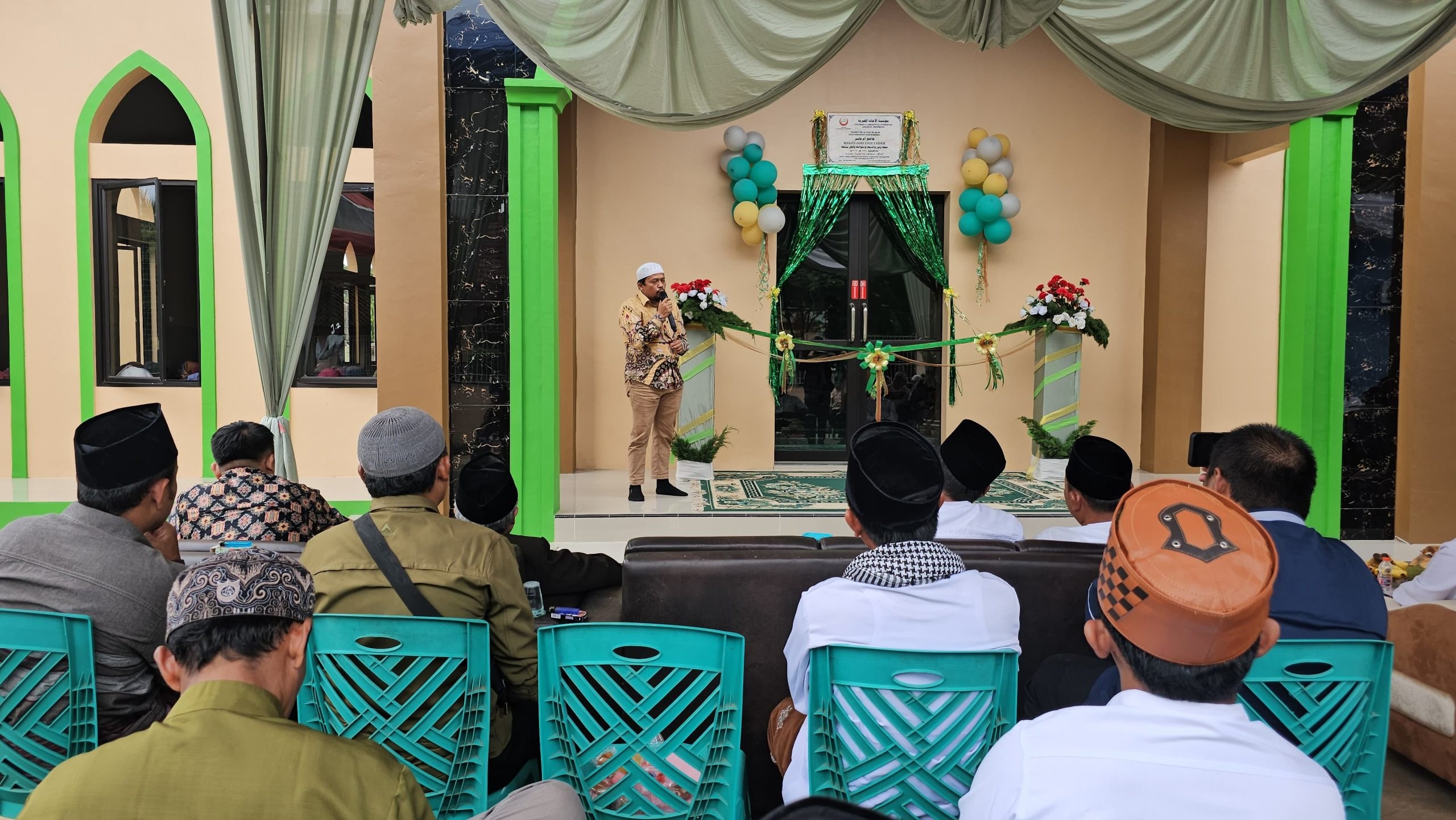 Participants gather outside the mosque building.