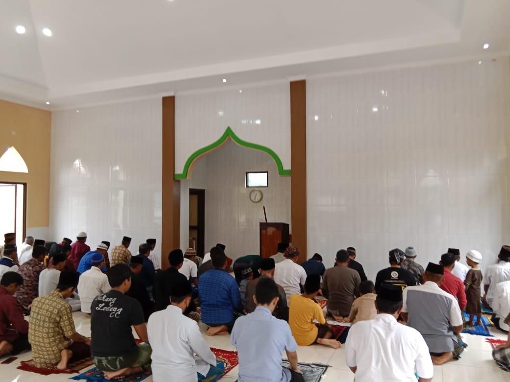 Worshippers gather inside the mosque prayer hall.