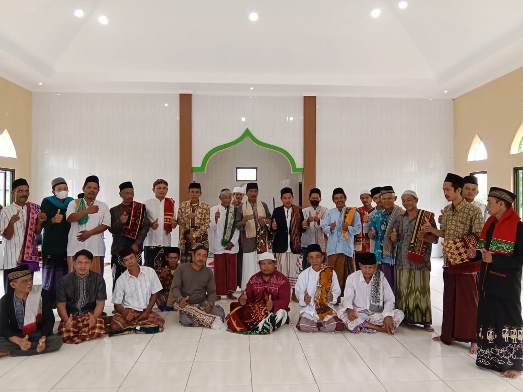 Participants stand together inside the mosque prayer hall.