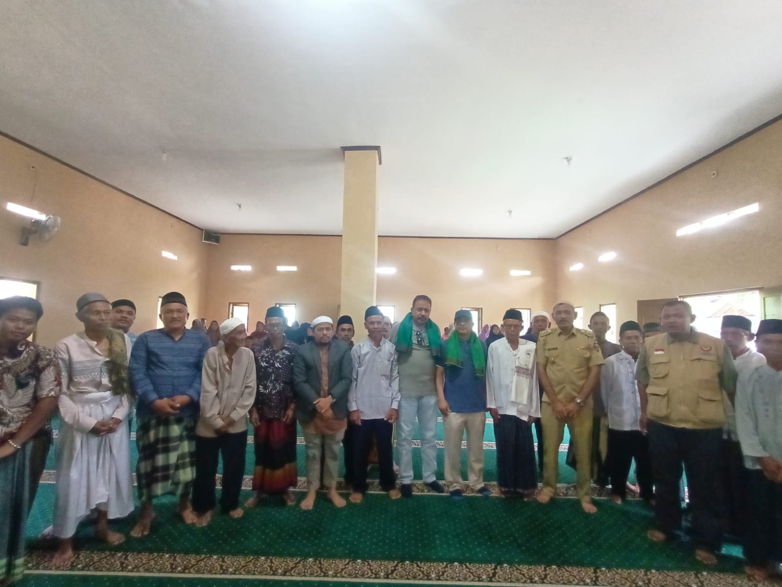 Participants stand together inside the mosque prayer hall.