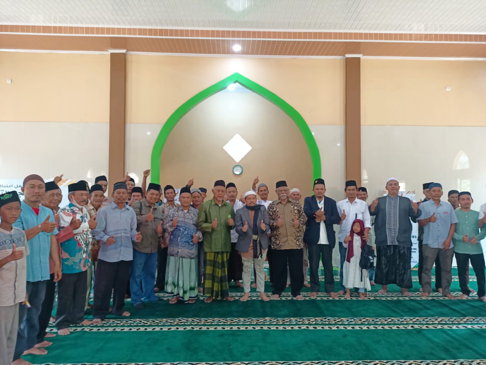 Participants stand together inside the mosque prayer hall.