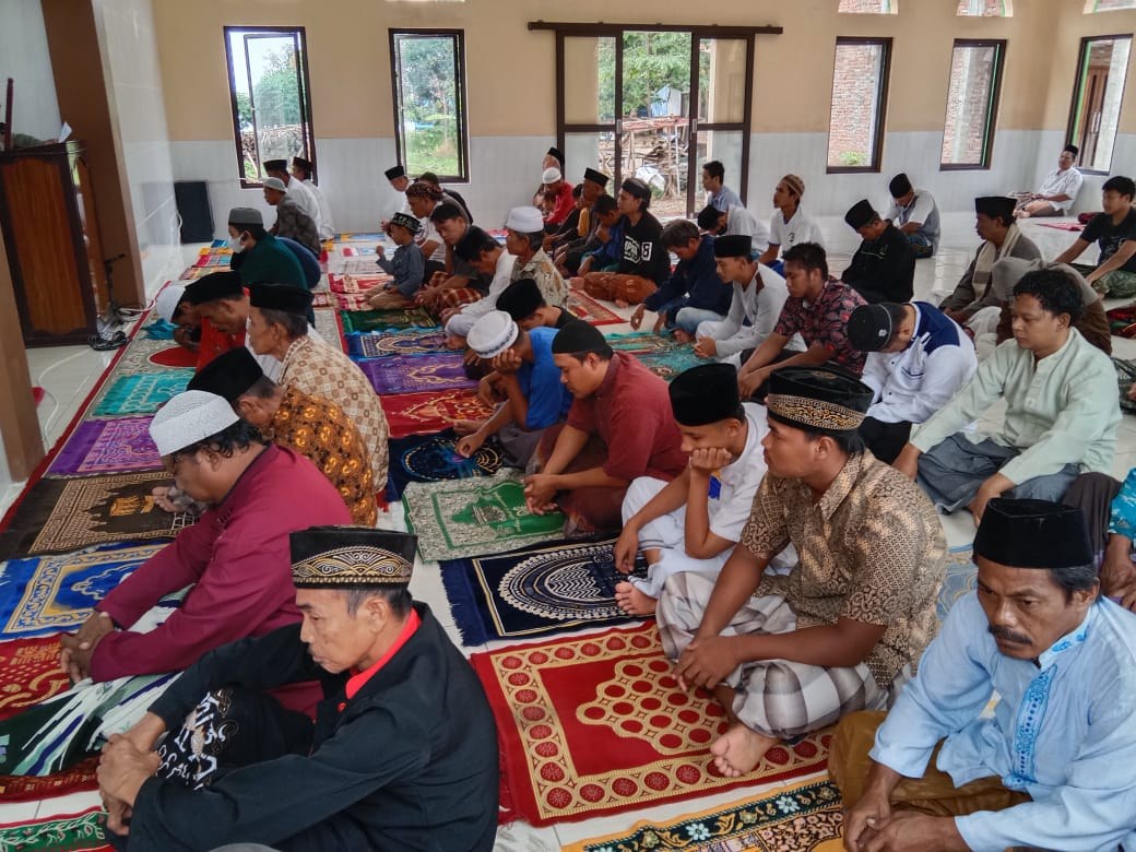 Worshippers gather inside the mosque prayer hall.