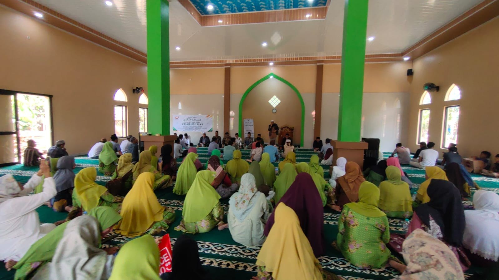 Worshippers gather inside the mosque prayer hall.