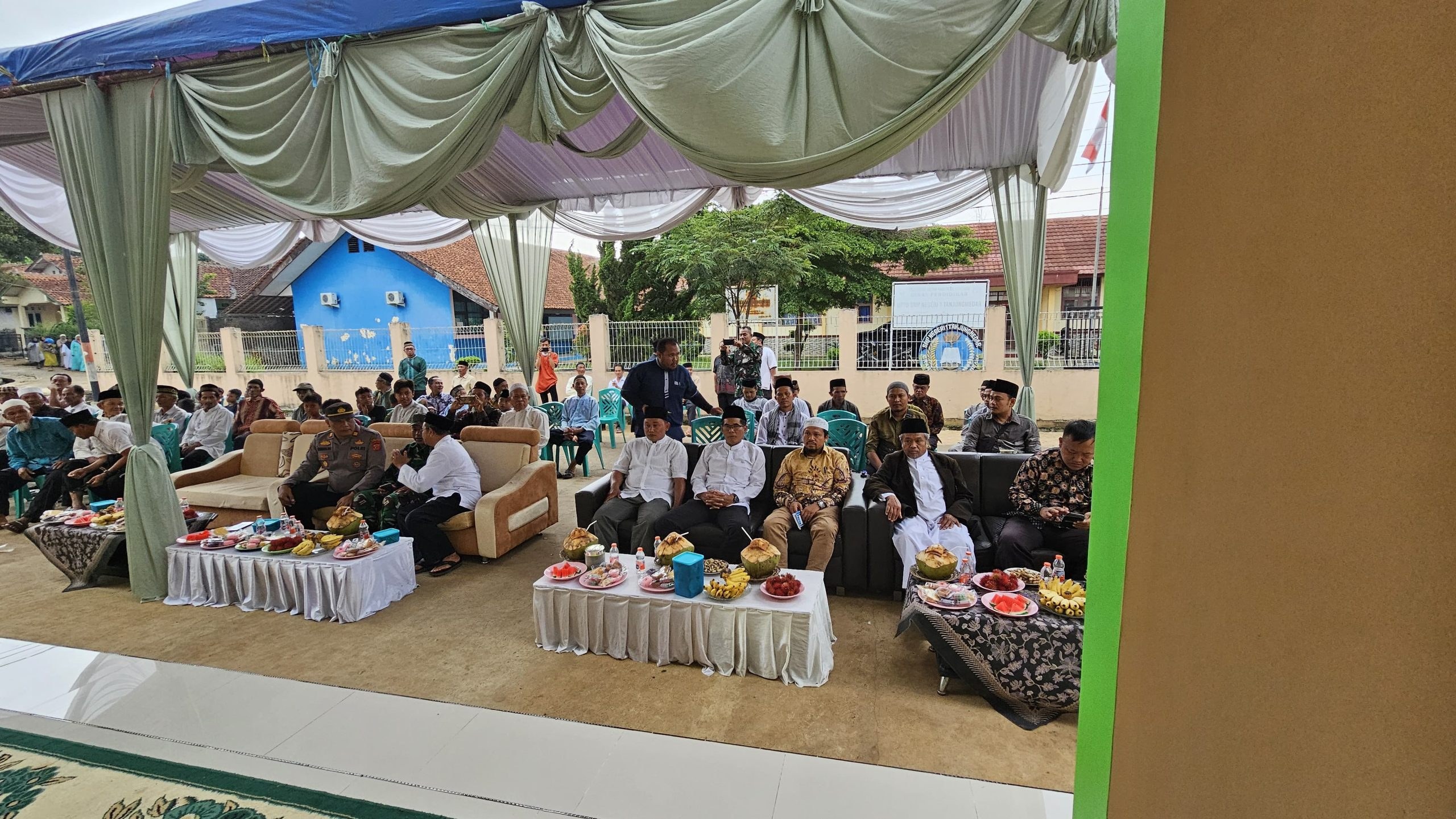 Guests seated beneath a canopy outside the mosque.